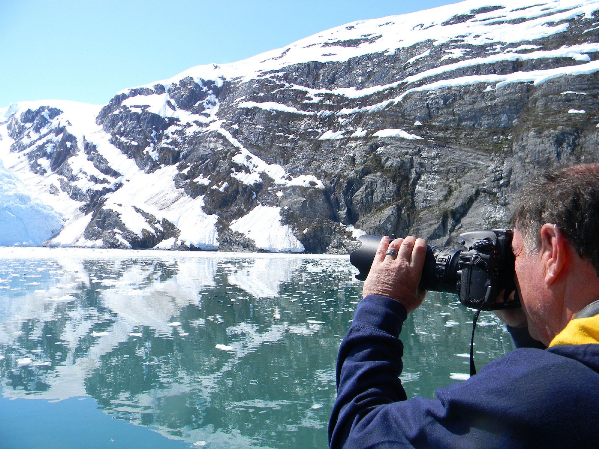 Man photographing glacier during glacier tour