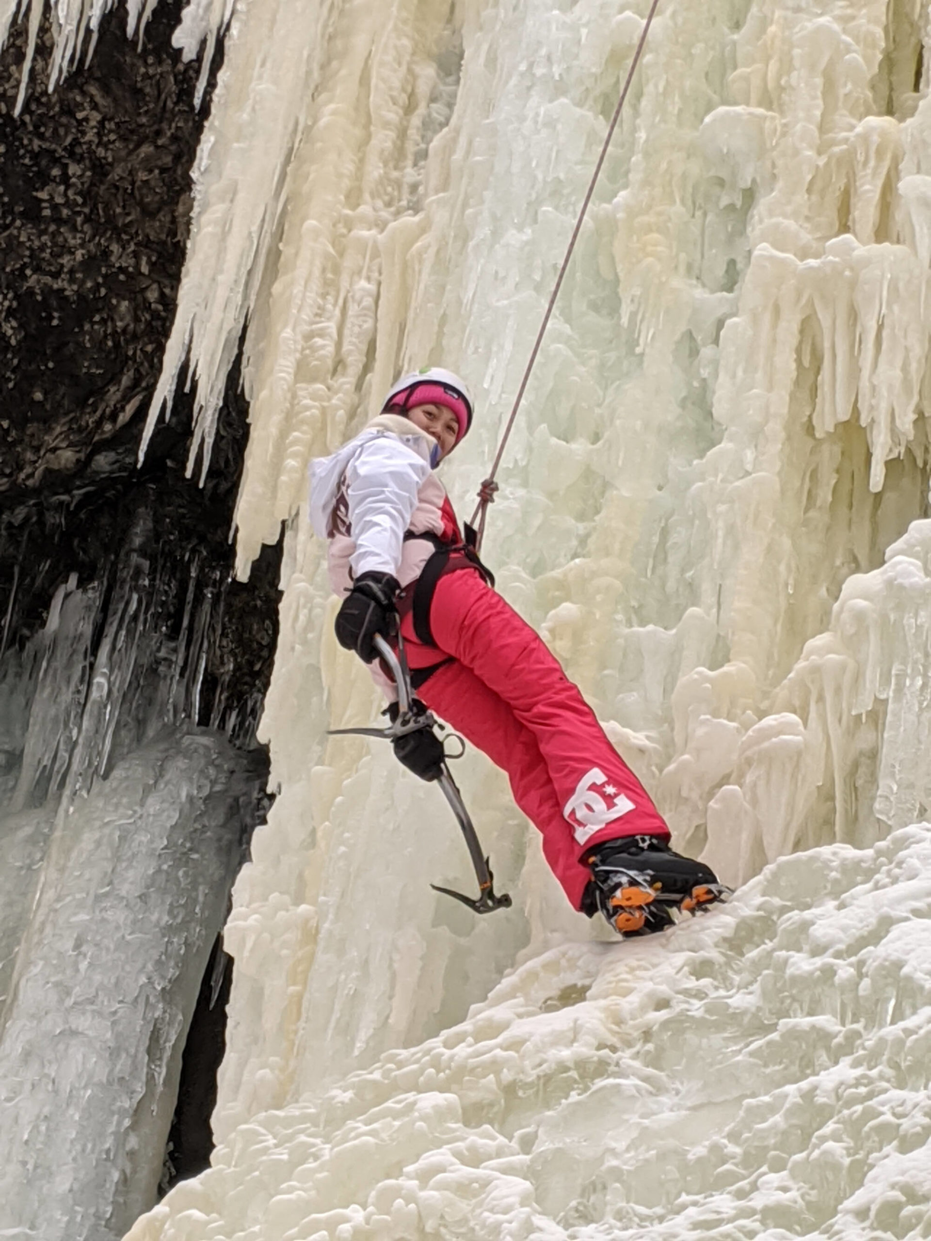 Woman ice climbing in alaska