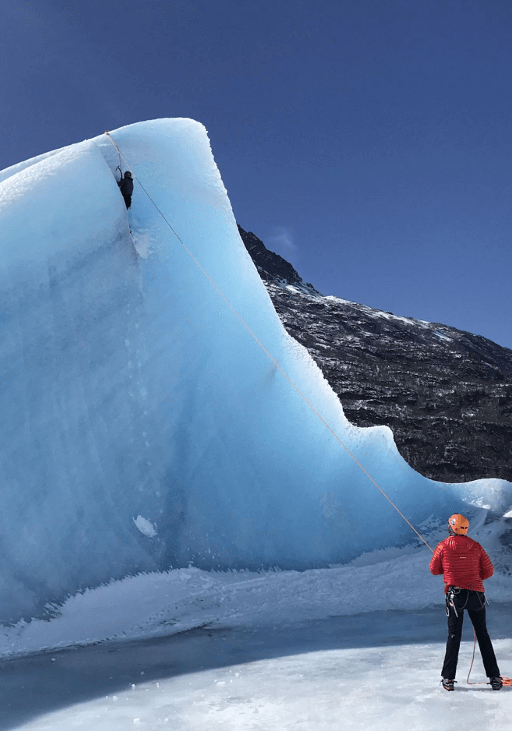 Two guests participate in ice climbing in Alaska