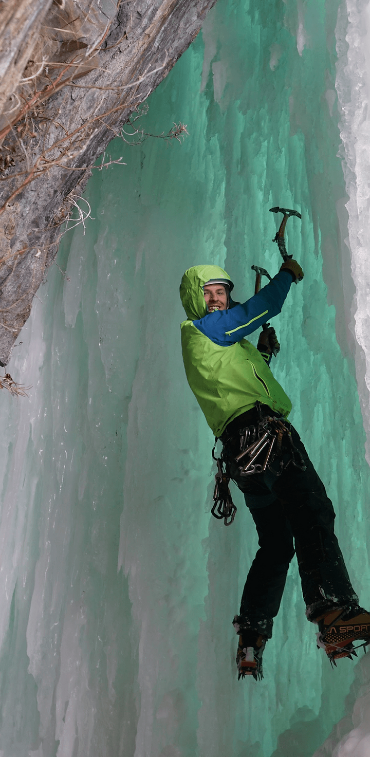 Smiling guest while ice climbing in Alaska after helicopter ride
