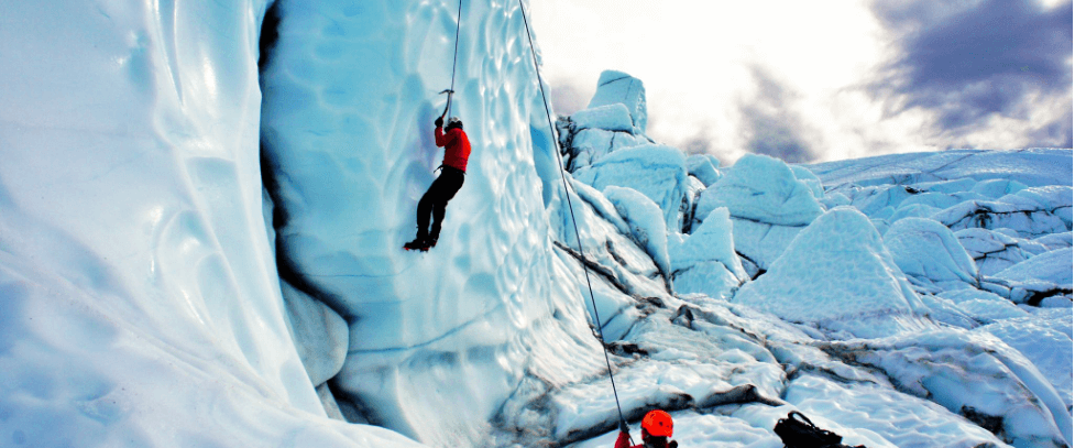 Two guests participate in ice climbing in Alaska