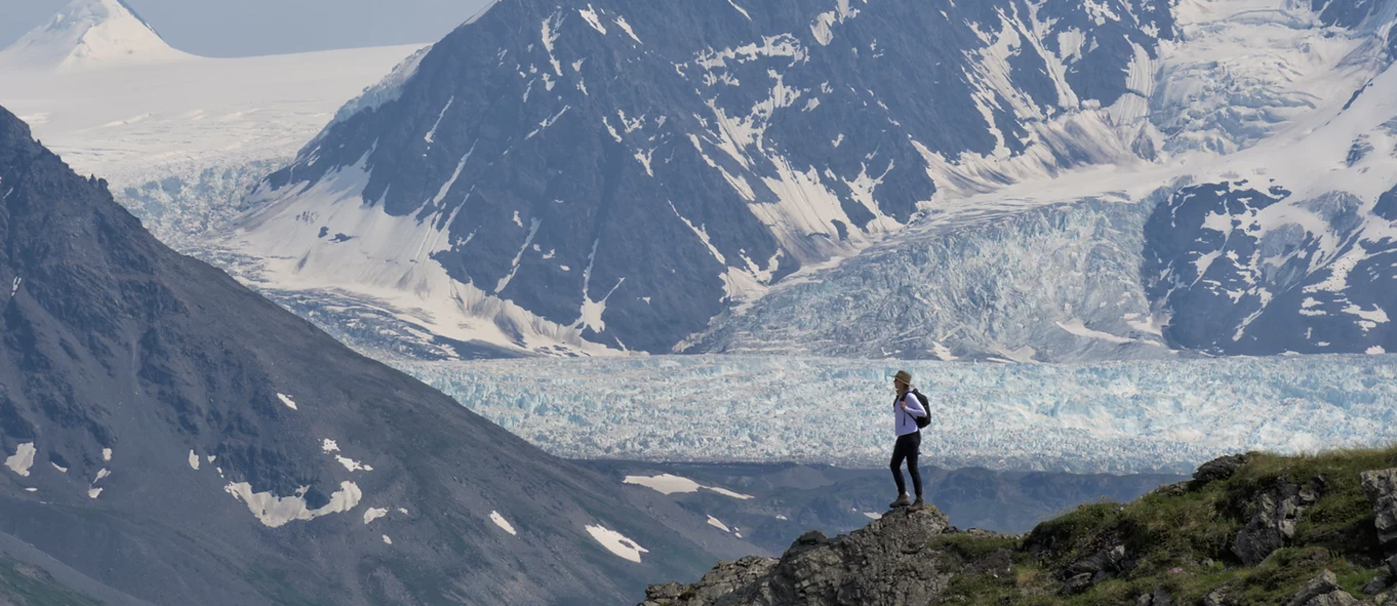 hiker takes in the views of an Alaskan glacier