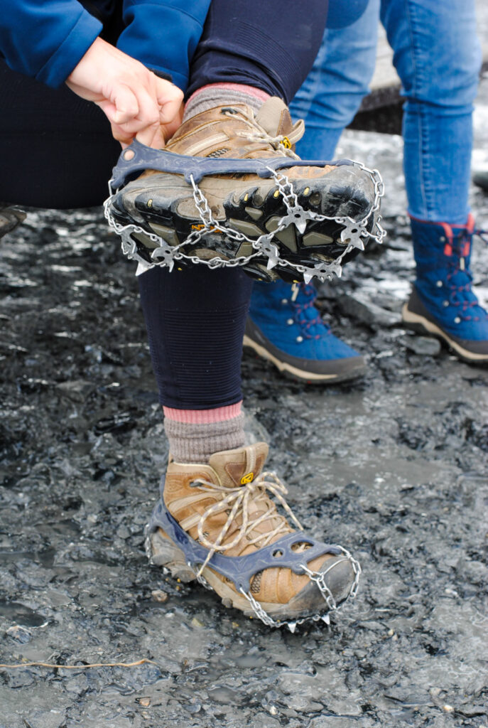 Putting on a crampon for Matanuska Glacier Tour